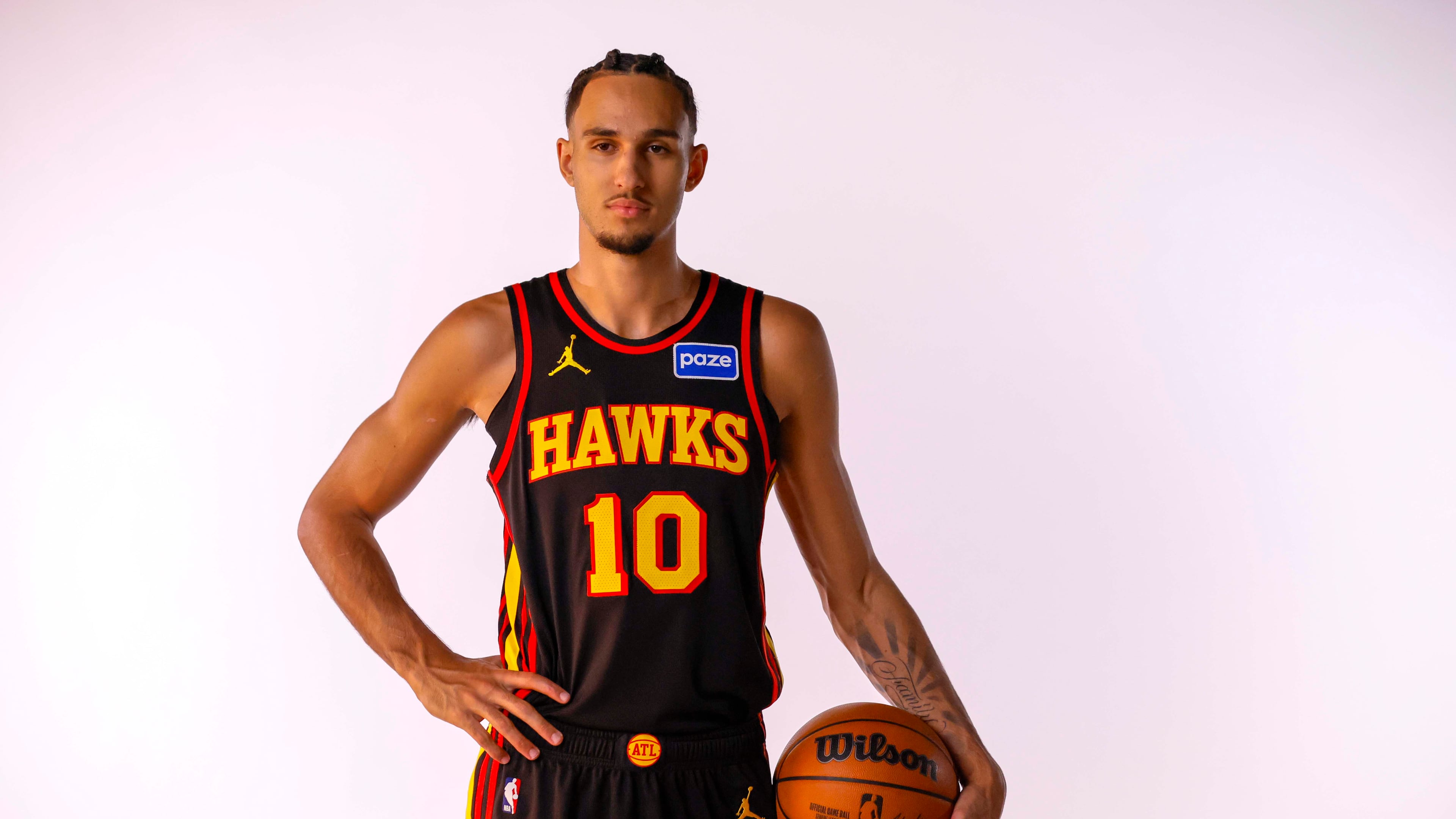 Hawks forward Zaccharie Risacher — pictured posing during media day last month — sat out along with most of Atlanta's regulars in Monday's 119-118 win over the Heat. In Atlanta's previous game agains the Grizzlies, Risacher scored 16 points. (Miguel Martinez/AJC)