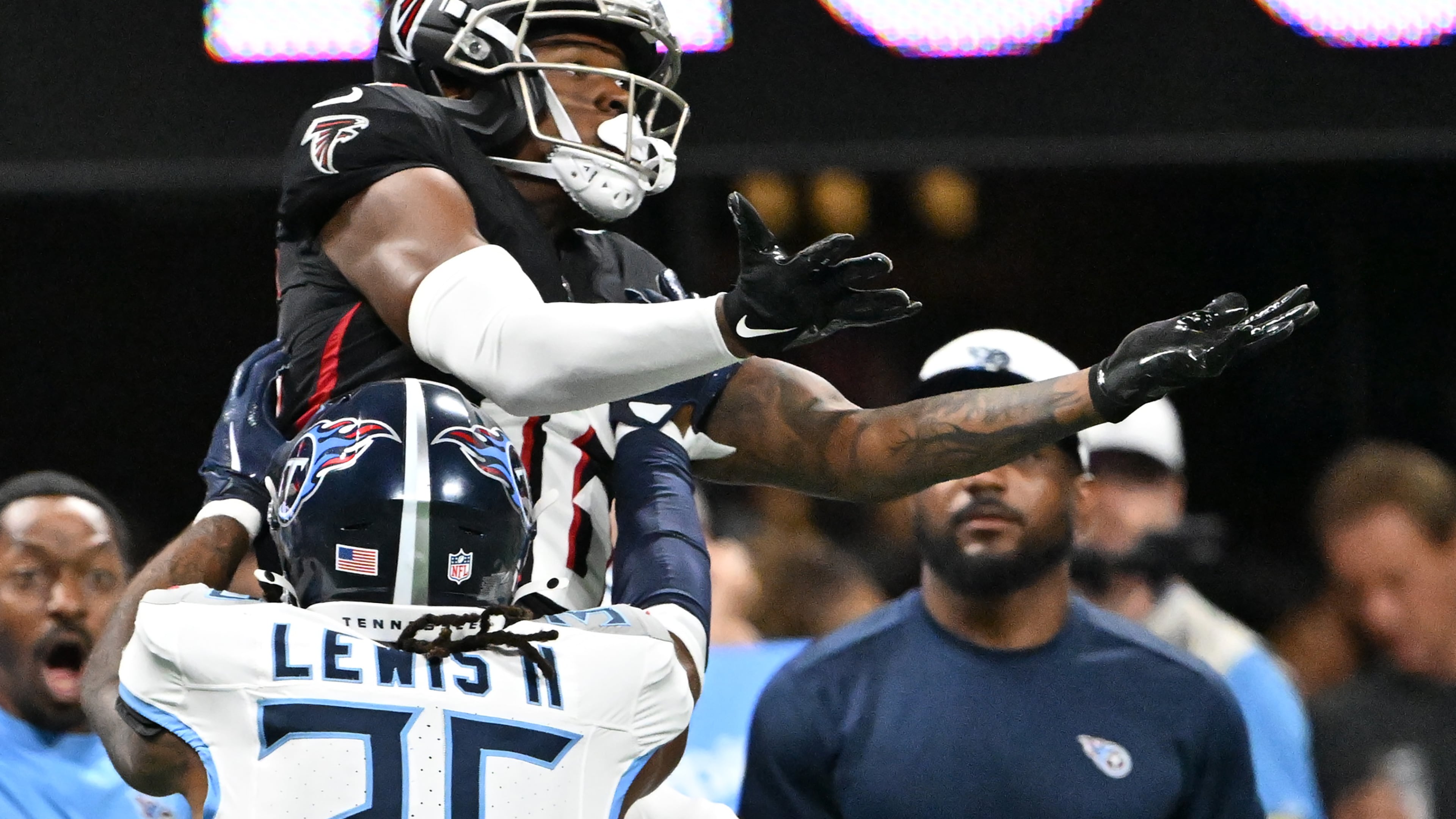 Atlanta Falcons wide receiver DJ Chark (16) makes a catch under pressure from Tennessee Titans cornerback Clarence Lewis (36) during the second half of an NFL preseason game at Mercedes-Benz Stadium, Friday, August 15, 2025, in Atlanta. Tennessee Titans won 23-20 over Atlanta Falcons. (Hyosub Shin / AJC)