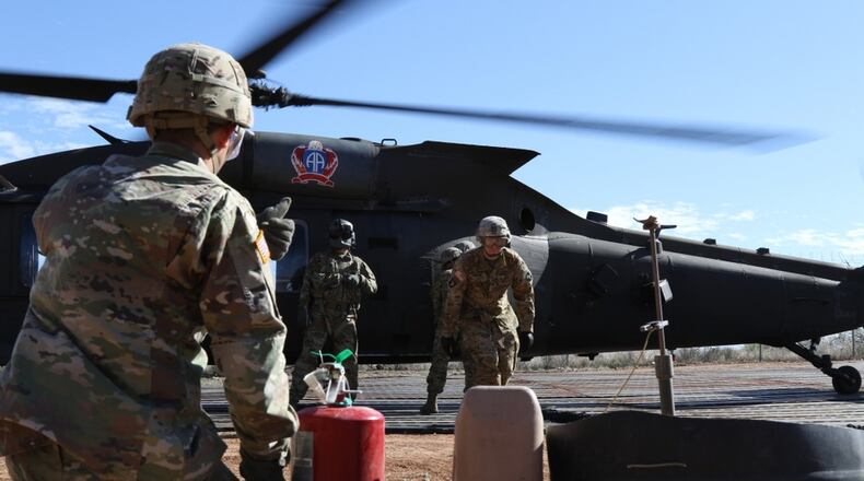 Soldiers from 227th Composite Supply Company, 101st Airborne Division, rush to refuel a Blackhawk helicopter in between missions in Sasabe, Ariz., on Nov. 20.