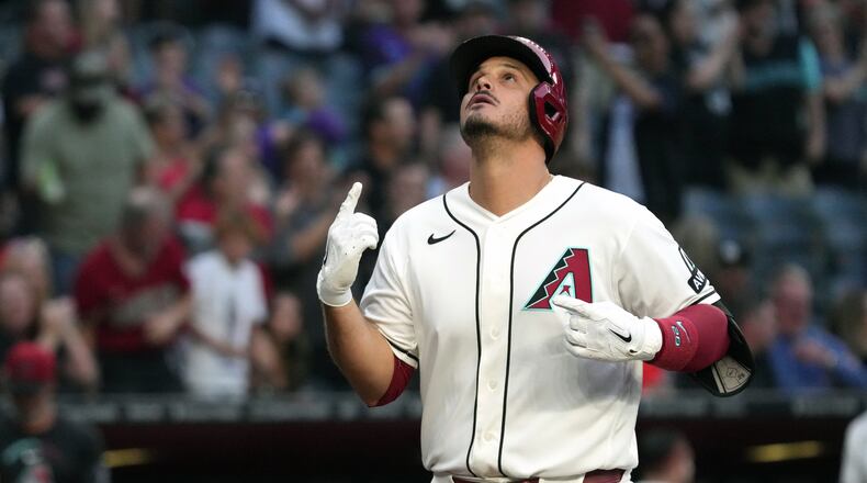 Arizona Diamondbacks' Nolan Arenado celebrates after hitting a grand slam against the San Francisco Giants in the first inning of a baseball game, Monday, May 18, 2026, in Phoenix. (AP Photo/Rick Scuteri)