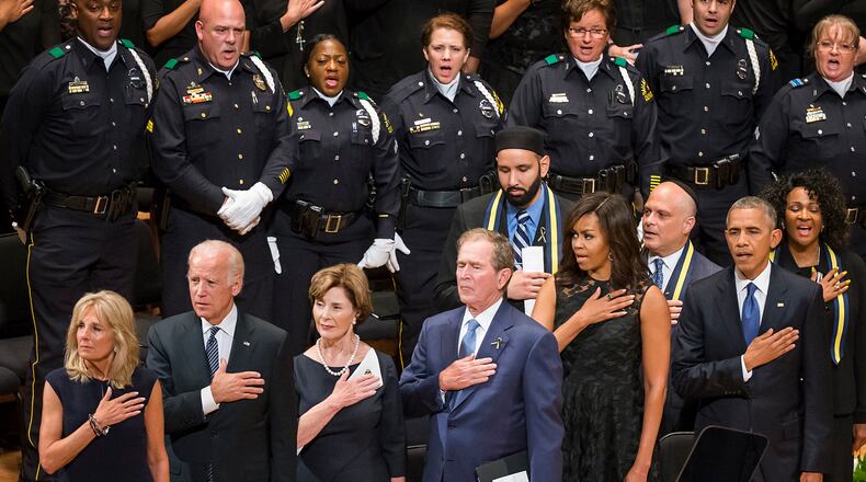From left, Jill Biden, Vice President Joe Biden, former first lady Laura Bush, former President George W. Bush, Michelle Obama and President Barak Obama stand for the national anthem during an interfaith memorial service at the Morton H. Meyerson Symphony Center in Dallas on Tuesday, July 12, 2016, for five law enforcement officers killed last week in an ambush at a Black Lives Matter rally. (Smiley N. Pool/The Dallas Morning News via AP) /The Dallas Morning News via AP) MANDATORY CREDIT; MAGS OUT; TV OUT; INTERNET USE BY AP MEMBERS ONLY; NO SALES
