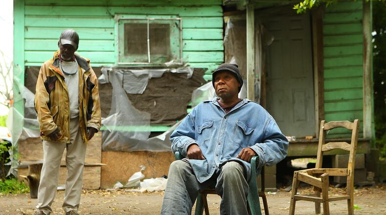 **** POSSIBLE VISUAL LEDE**** 032915 PELHAM: Poverty stricken Adel Edwards, 54, sits outside his home by a small pile of leaves with his friend Henry Smith, 62, who is often with him on Monday, March 30, 2015, in Pelham. Edwards was fined $500 by a judge for burning without a permit and was placed on 12 months of probation with a private probation company. Curtis Compton / ccompton@ajc.com