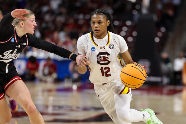 South Carolina guard MiLaysia Fulwiley (12) drives the ball around Indiana guard Lexus Bargesser (1) during the first half in the second round of the NCAA college basketball tournament, Sunday, March 23, 2025, in Columbia, S.C. (AP Photo/David Yeazell)