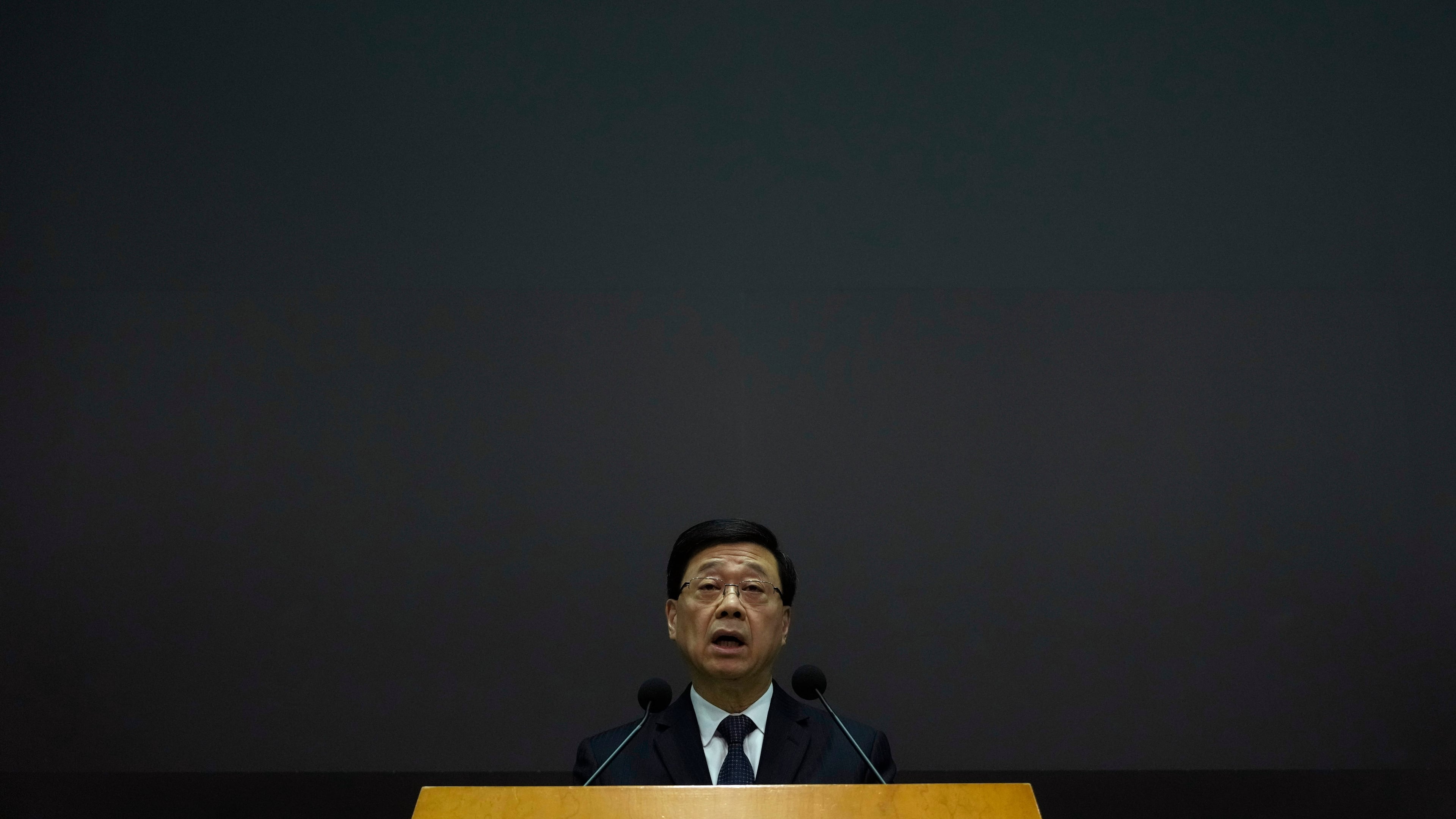 Hong Kong Chief Executive John Lee speaks during a press conference with a darken screen in the aftermath of a deadly fire in Hong Kong on Tuesday, Dec. 2, 2025. (AP Photo/Ng Han Guan)