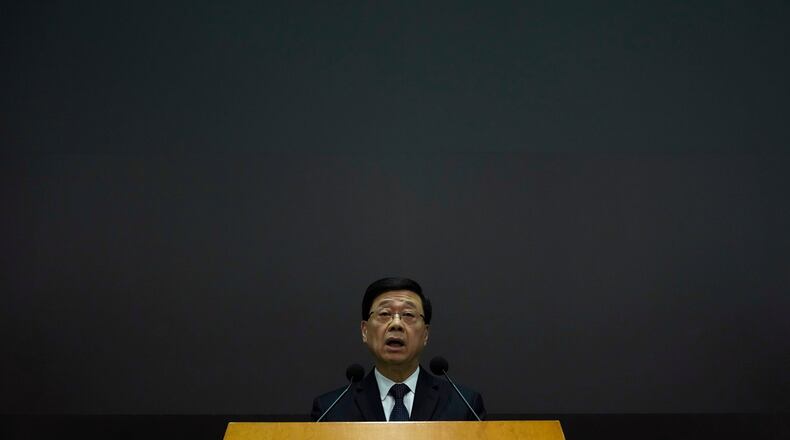 Hong Kong Chief Executive John Lee speaks during a press conference with a darken screen in the aftermath of a deadly fire in Hong Kong on Tuesday, Dec. 2, 2025. (AP Photo/Ng Han Guan)