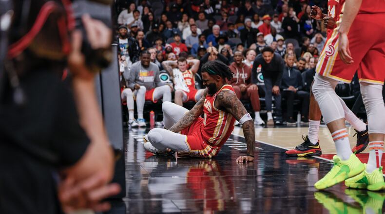 Atlanta Hawks forward Saddiq Bey (41) grabs his leg after a bad landing during the second half against the New Orleans Pelicans at State Farm Arena, Sunday, March 10, 2024, in Atlanta.
 Miguel Martinez / miguel.martinezjimenez@ajc.com