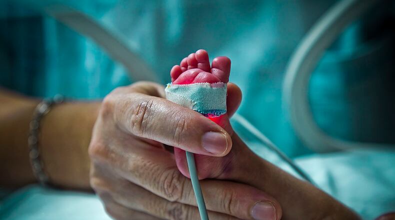 A premature baby in an incubator receives care from a doctor. A Virginia baby born at just 24 weeks in 2015 has celebrated another milestone.