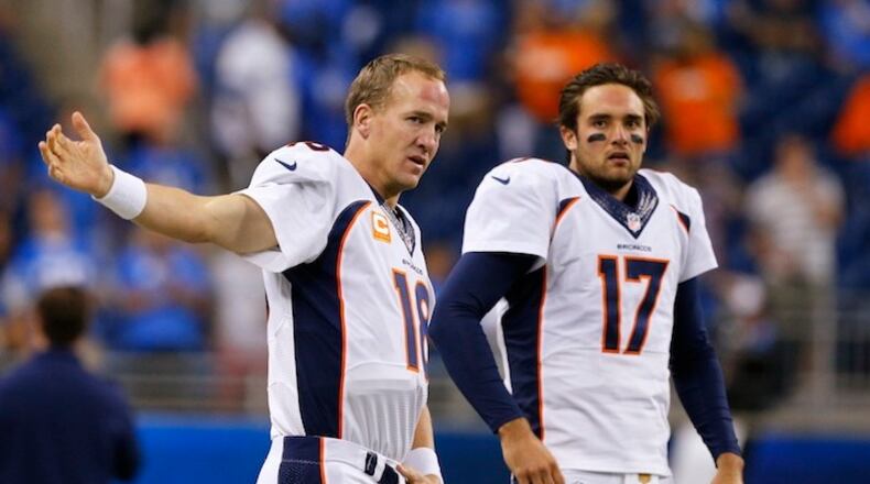 FILE - In this Sept. 27, 2015, file photo, Denver Broncos quarterbacks Peyton Manning (18) and Brock Osweiler (17) get ready for the Broncos' NFL football game against the Detroit Lions in Detroit. Who will start for the Broncos in the Jan. 17 divisional playoff game? (AP Photo/Rick Osentoski, File)