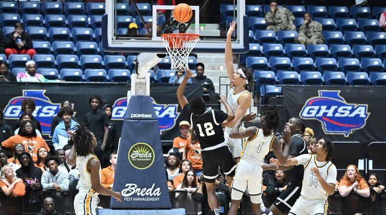 Kell’s CJ Brown (12) goes to the basket for the shot during 2023 GHSA Basketball Class 5A Boy’s State Championship game at the Macon Centreplex, Thursday, March 9, 2023, in Macon, GA. Kell won 61-53 over Eagle's Landing. Brown was named MVP of the Arby's Classic tournament. (Hyosub Shin / Hyosub.Shin@ajc.com)