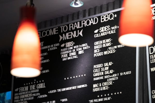 The menu at Railroad BBQ in Columbia, South Carolina on November 30, 2025. Bridging politics, local history and the culinary world — the restaurant is located steps from Benedict College and Allen University. (Sean Rayford for the AJC) 