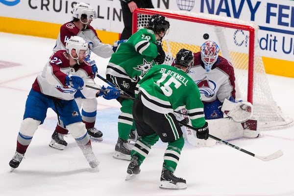 A shot by Dallas Stars center Colin Blackwell (15) gets by Colorado Avalanche goaltender Mackenzie Blackwood, right, for the game-winning goal during overtime in Game 2 of a first-round NHL hockey playoff series early Tuesday, April 22, 2025, in Dallas. (AP Photo/Julio Cortez)