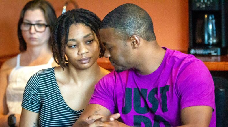 Amber Jackson sits next to her boyfriend Andre Williams at a press conference in Decatur on Friday, June 25, 2021, concerning her body-slam lawsuit against two Atlanta police officers and the city of Atlanta. (STEVE SCHAEFER FOR THE ATLANTA JOURNAL-CONSTITUTION)