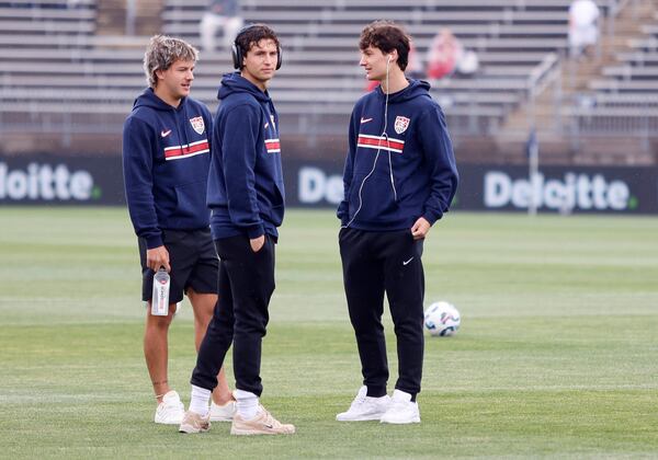 United States defender John Tolkin, left, talks with teammates Brenden Aaronson, center, and forward Paxten Aaronson before the start of an international friendly soccer game against Turkey, Saturday, June 7, 2025, in East Hartford, Conn. (AP Photo/Mary Schwalm)