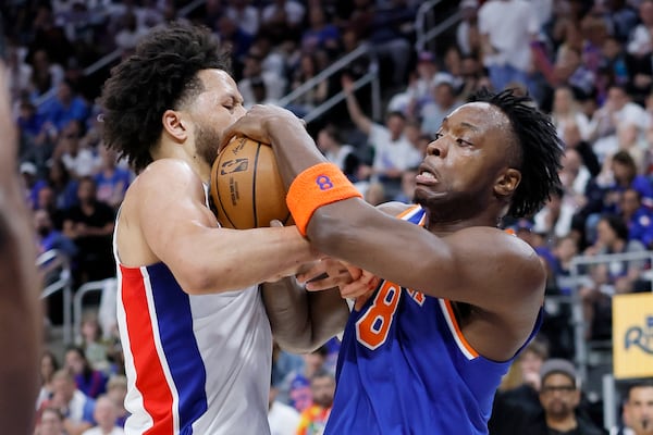 Detroit Pistons guard Cade Cunningham, left, steals the ball from New York Knicks forward OG Anunoby (8) during the first half of Game 3 of an NBA basketball first-round playoff series Thursday, April 24, 2025, in Detroit. (AP Photo/Duane Burleson)