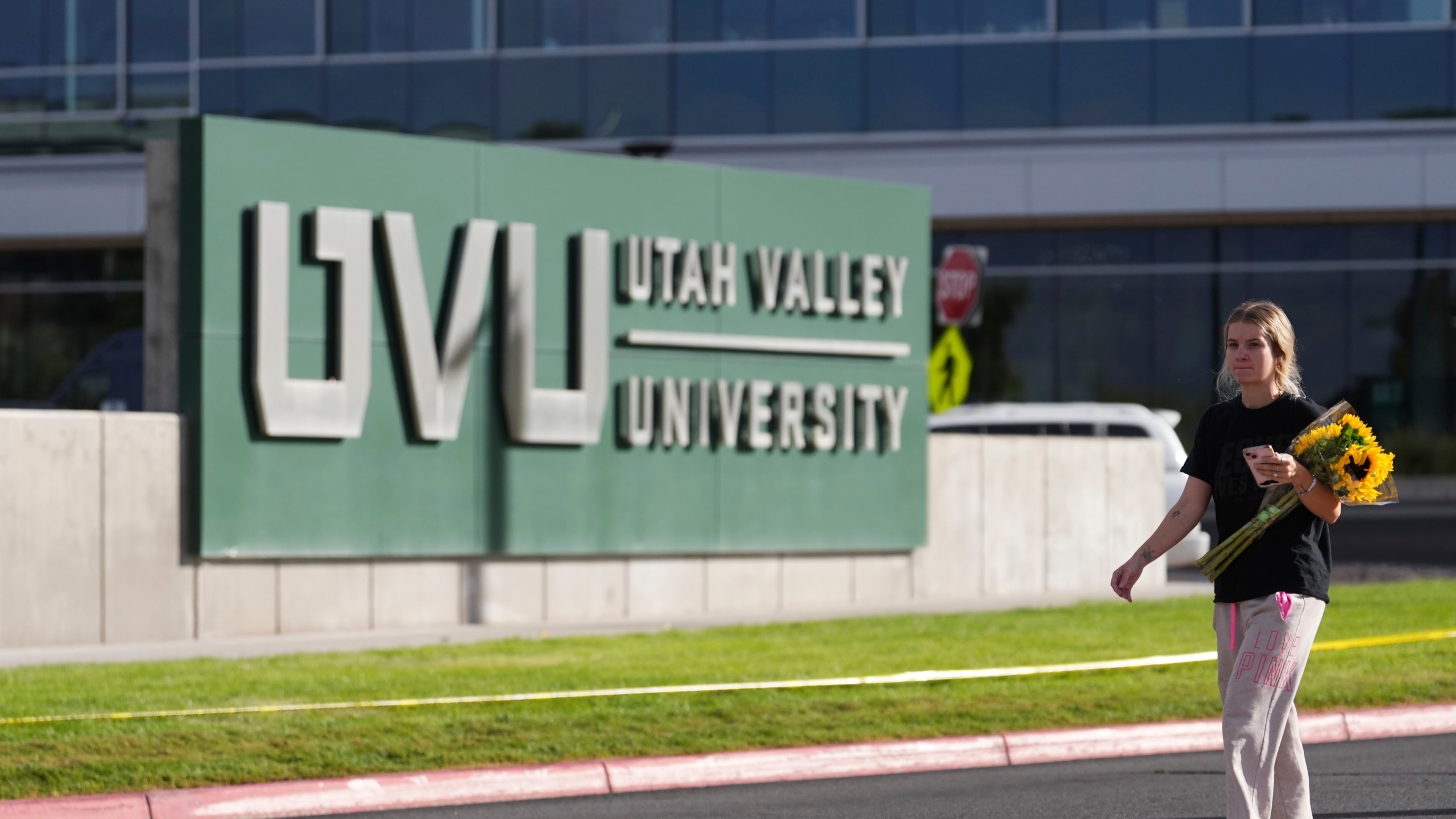 Meagan Bradley walks to a memorial for Charlie Kirk at Utah Valley University in Orem, Utah, Friday, Sept. 12, 2025. (AP Photo/Lindsey Wasson)