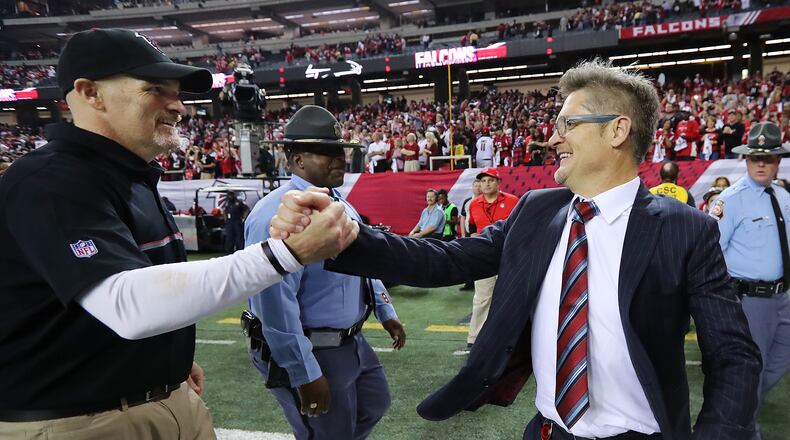Falcons coach Dan Quinn celebrates with his brother from another mother, general manager Thomas Dimitroff, after beating Seattle last week. (Curtis Compton/ccompton@ajc.com)