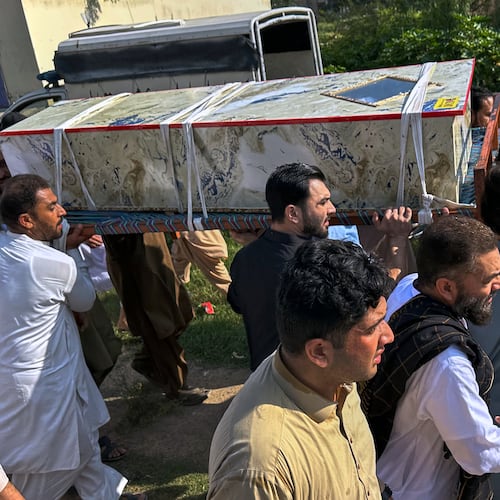 In this photo taken with a smartphone, mourners carry the casket of a victim who was killed in Friday's suicide bombing at a mosque, for a funeral in Kohat, in northwestern Pakistan, Saturday, Sept. 19, 2026. (AP Photo/Maaz Awan)