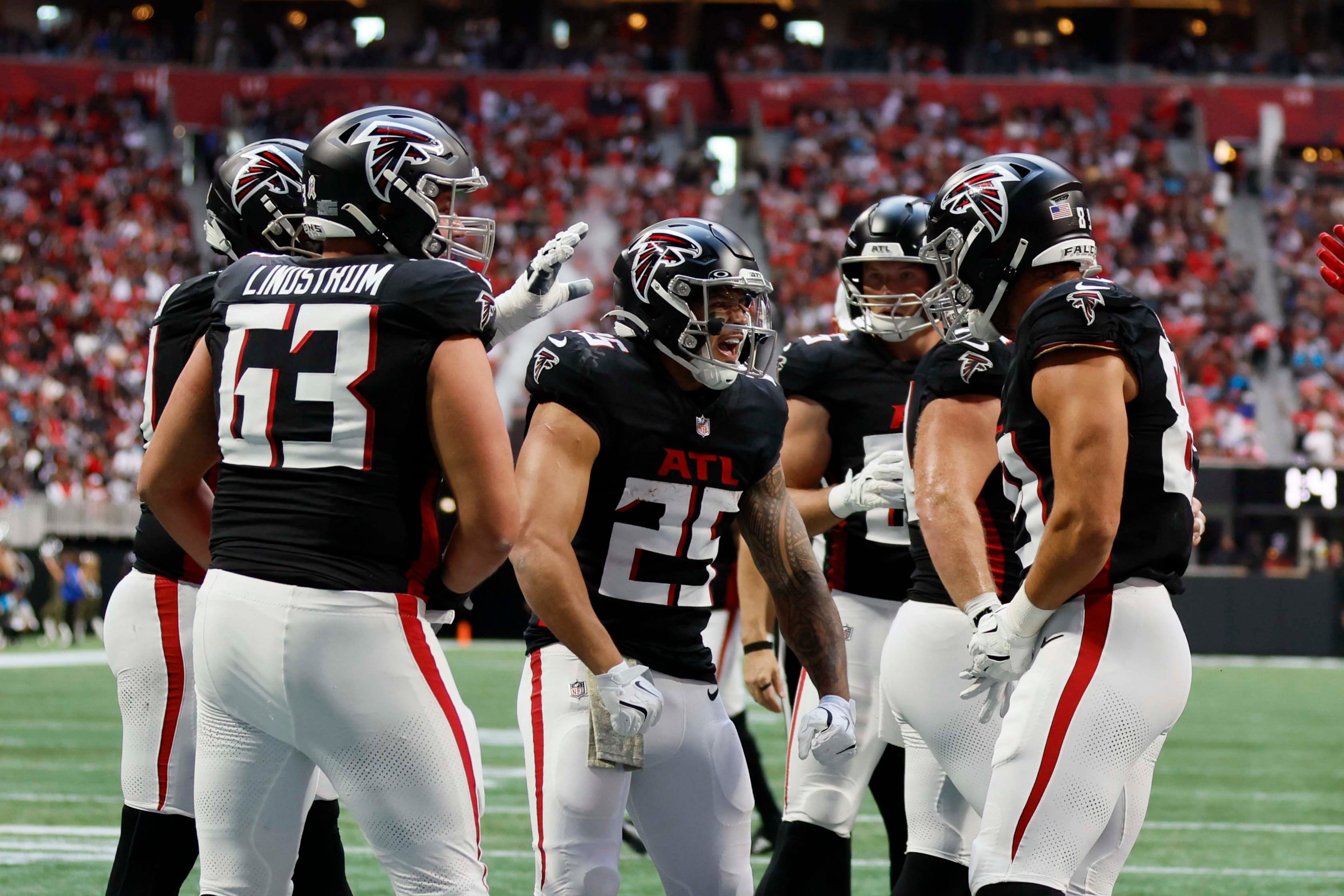Atlanta Falcons running back Tyler Allgeier (center) reacts with teammates after scoring his team's third touchdown during the first half of an NFL football game against the Carolina Panthers at Mercedes-Benz Stadium in Atlanta on Sunday, Nov. 16, 2025. (Miguel Martinez/AJC)