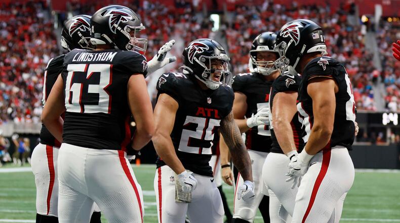 Atlanta Falcons running back Tyler Allgeier (25) reacts with teammates after scoring his team's third touchdown during the first half of an NFL football game against the Carolina Panthers at Mercedes-Benz Stadium in Atlanta on Sunday, Nov. 16, 2025.
(Miguel Martinez/ AJC)