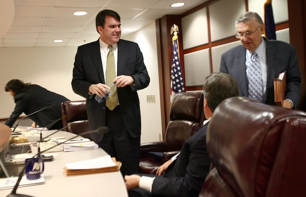 Chuck Eaton talks with former commissioners Stan Wise and Doug Everett after presiding over an administrative session. (BEN GRAY / Staff)