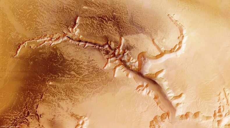 IN SPACE - JULY 16: In this handout image supplied by the European Space Agency (ESA) on July 16, 2008, The Echus Chasma, one of the largest water source regions on Mars, is pictured from ESA's Mars Express. The data was acquired on September 25, 2005. The dark material shows a network of light-coloured, incised valleys that look similar to drainage networks known on Earth. It is still debated whether the valleys originate from precipitation, groundwater springs or liquid or magma flows on the surface. (Photo by ESA via Getty Images)