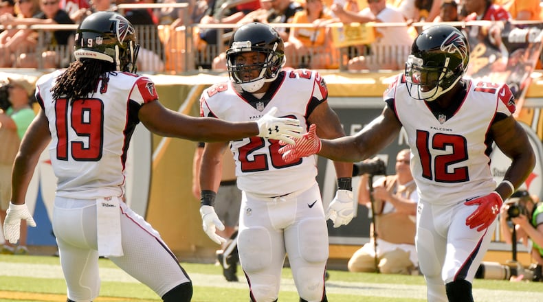 Atlanta Falcons running back Terron Ward (28), left, is congratulated by wide receivers Mohamed Sanu (12) and Andre Roberts (19) after scoring a touchdown in the first quarter of an NFL preseason football game against the Pittsburgh Steelers, Sunday, Aug. 20, 2017, in Pittsburgh. (AP Photo/Don Wright)
