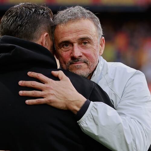 PSG's head coach Luis Enrique, right, hugs Lens' head coach Pierre Sage prior to the start of the French League One soccer match between Lens and Paris Saint Germain, in Lens, northern France, Wednesday, May 13, 2026. (AP Photo/Jean-Francois Badias)