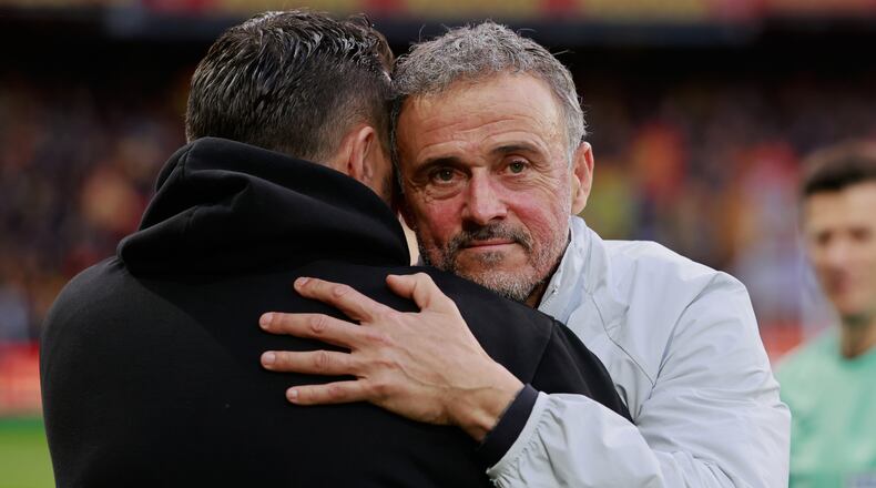 PSG's head coach Luis Enrique, right, hugs Lens' head coach Pierre Sage prior to the start of the French League One soccer match between Lens and Paris Saint Germain, in Lens, northern France, Wednesday, May 13, 2026. (AP Photo/Jean-Francois Badias)