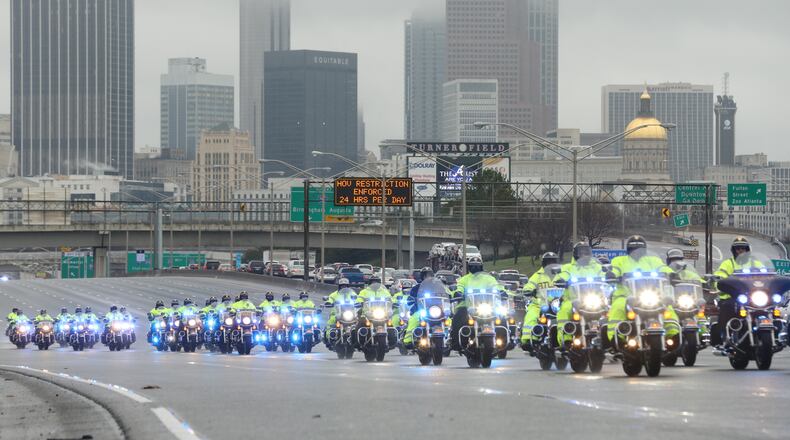 Drivers should expect delays as the procession for Fulton police Det. Terence Avery Green makes its way across the city from Turner Field to World Changer’s Church International for the 1 p.m. funeral. JOHN SPINK / JSPINK@AJC.COM