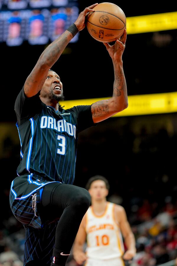 Orlando Magic guard Kentavious Caldwell-Pope (3) drives against the Atlanta Hawks during the first half of an NBA basketball game, Sunday, April 13, 2025, in Atlanta. (AP Photo/Mike Stewart)