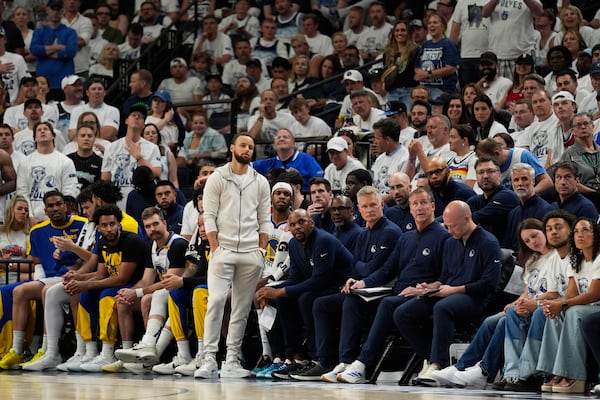 Golden State Warriors guard Stephen Curry (30) looks on near the bench during the second half of Game 5 of an NBA basketball second-round playoff series against the Minnesota Timberwolves, Wednesday, May 14, 2025, in Minneapolis. (AP Photo/Abbie Parr)