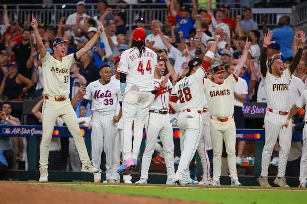 National League players celebrate after designated hitter Kyle Schwarber of the Philadelphia Phillies hit a homer to win the MLB All-Star Game in a swing-off against the American League when both teams were tied at 6 after nine innings at Truist Park in Atlanta on Tuesday, July 15, 2025. (Jason Getz/AJC)