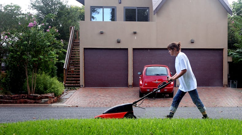 Ricardo B. Brazziell AMERICAN-STATESMAN 8/18/07 Katherine Weil mows a lawn with an environmental friendly mower in north Austin on Saturday Morning, August 18, 2007.