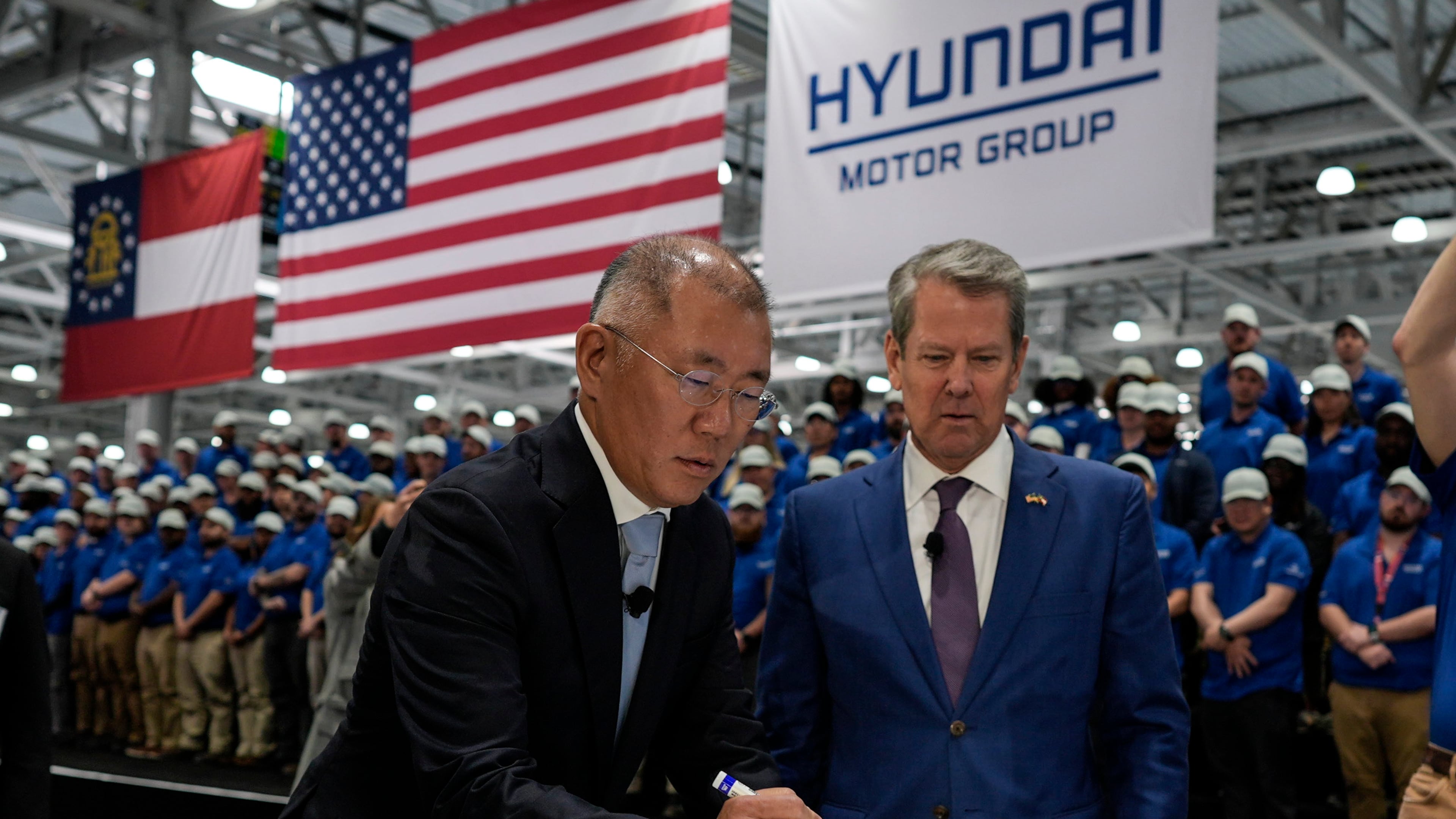 Hyundai executive Euisun Chung stands with Georgia Gov. Brian Kemp at the automaker's Metaplant in southeast Georgia in March 2025. (Mike Stewart/AP)