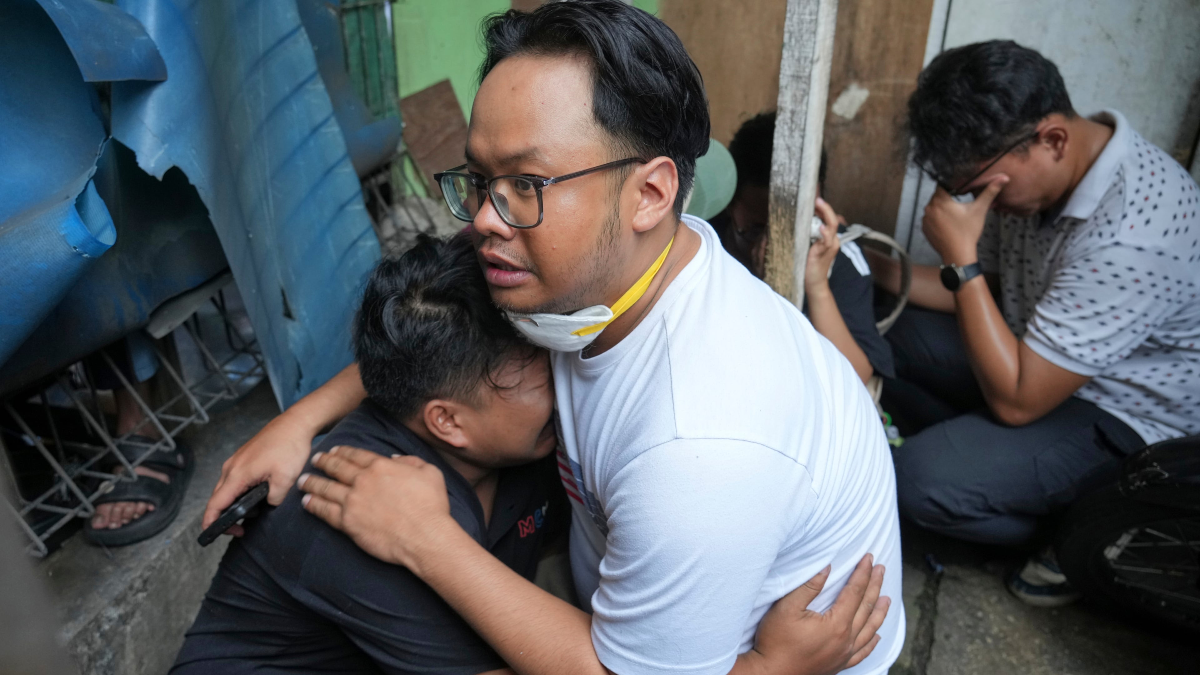 A man cries at the site of a fire in Jakarta, Indonesia, Tuesday, Dec. 9, 2025. (AP Photo/Dita Alangkara)