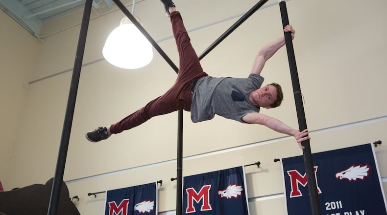 Milton High School student Cole Dobbs performs a move call the “human flag” on Chinese poles in a unique Milton High School class inspired by Cirque du Soleil. (Photo by Phil Skinner)