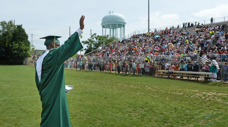 Hezekiah Jordan, son of fallen Griffin police officer Kevin Jordan, waves after he received his diploma during the Griffin High School 2014 Graduation Ceremony. I hope someone cheered without being arrested. (HYOSUB SHIN / HSHIN@AJC.COM)