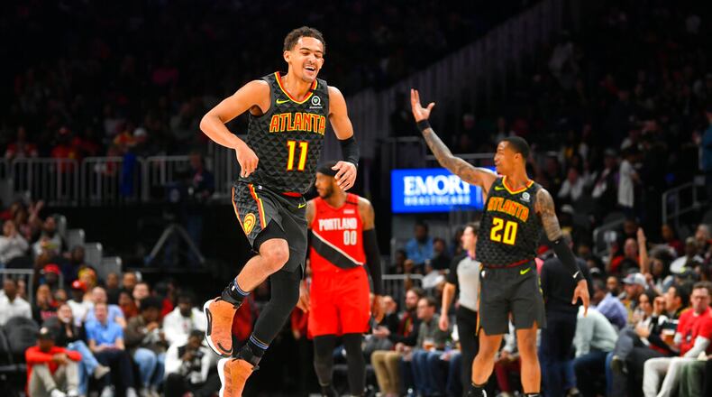 Atlanta Hawks guard Trae Young (11) reacts after a long range assist during the second half of an NBA basketball game against thePortland Trail Blazers, Saturday, Feb. 29, 2020, in Atlanta. (AP Photo/John Amis)