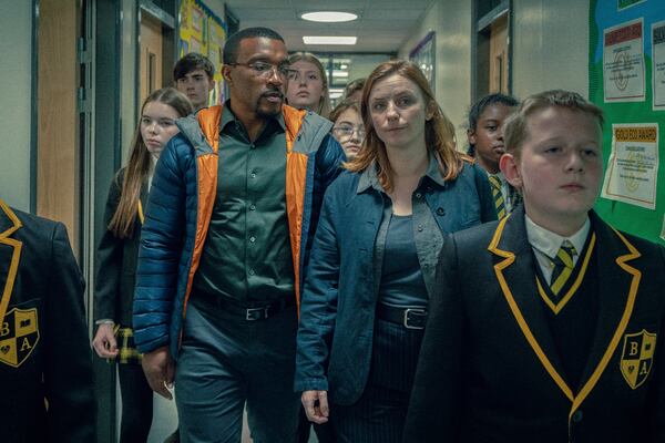 This image released by Netflix shows Ashley Walters, center left, and Faye Marsay, center right, in a scene from "Adolescence." (Netflix via AP)