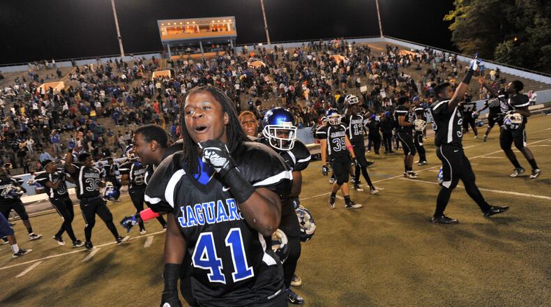 Stephenson's Kyseem Tillman (41) and other players celebrate team's 13-6 victory over Tucker in the battle of DeKalb County powers.