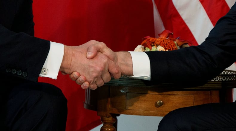FILE - President Donald Trump shakes hands with French President Emmanuel Macron during a meeting at the U.S. Embassy, May 25, 2017, in Brussels. (AP Photo/Evan Vucci, file)