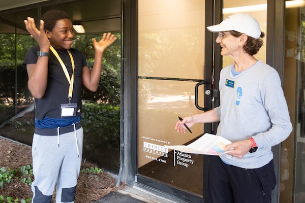 Lisa Aman (right), executive director of Kate’s Club, talks with Jaleel Miller-Kendall, 13, during a clubhouse gathering in Brookhaven. (Ben Gray for the AJC)