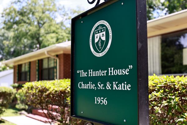 Views of the home marker in front of the house of prominent businessman Charlie Hunter Sr. on Friday, July 29, 2022. The house is the first in a historic Black neighborhood to receive a home marker. (Natrice Miller/natrice.miller@ajc.com)