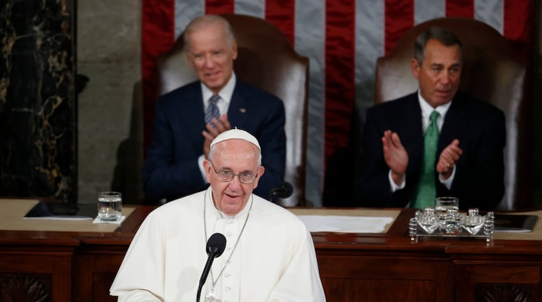 Pope Francis addresses a joint meeting of Congress on Capitol Hill in Washington, Thursday, Sept. 24, 2015, making history as the first pontiff to do so. Listening behind the pope are Vice President Joe Biden and House Speaker John Boehner of Ohio. (AP Photo/Carolyn Kaster)
