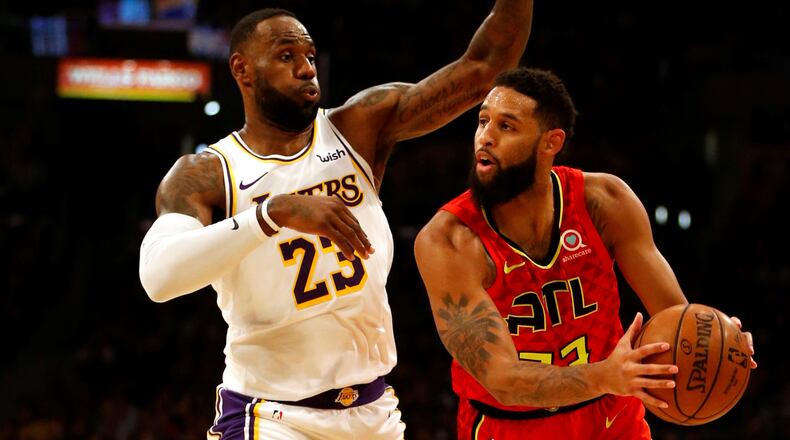 Allen Crabbe of the Atlanta Hawks drives around LeBron James of the Los Angeles Lakers during the first half of a game at Staples Center on November 17, 2019 in Los Angeles, California.