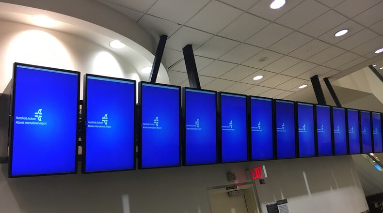 Screens that typically show the status of incoming and outgoing flights at Hartsfield-Jackson International Airport were blank early Monday. BEN BRASCH / BEN.BRASCH@COXINC.COM