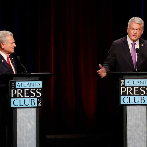U.S. Rep. Mike Collins, R-Jackson, responds to a question from U.S. Rep. Buddy Carter, R-St. Simons Island, during the Atlanta Press Club's Republican Loudermilk-Young debate at Georgia Public Broadcasting in Midtown, Atlanta, on Sunday, April 26, 2026. (Miguel Martinez/Atlanta Journal-Constitution via AP)