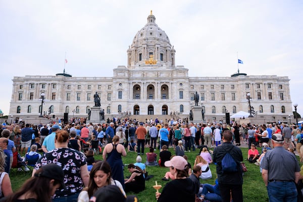 People attend a candlelight vigil for former House Speaker Melissa Hortman and her husband Mark, who were fatally shot, at the state Capitol, Wednesday, June 18, 2025, in St. Paul, Minn. (AP Photo/Nikolas Liepins)