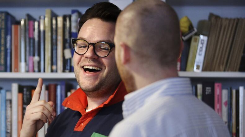 Casper ter Kuile, left, and his husband, Sean Lair, lead a virtual community choir from their living room in the Brooklyn borough of New York on Sunday, March 29, 2020. Created to combat social isolation in times of coronavirus, more than one hundred people from around the world joined the hour-long sing along session. (AP Photo/Jessie Wardarski)