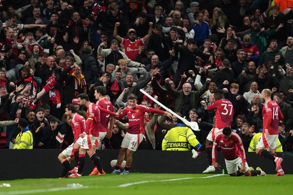 Manchester United's Harry Maguire, left, celebrates with team mates after his side's fifth goal during the Europa League quarter final second leg soccer match between Manchester United and Olympique Lyon in Manchester, Britain, Thursday, April 17, 2025. (AP Photo/Jon Super)